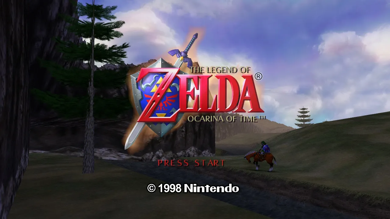 Title screen of The Legend of Zelda – Ocarina of Time with the game emblem in the front and main character Link in the back, sitting on horse Epona close to a river that runs through a grassy plain. There is a blue sky in the back and mountains on the left.