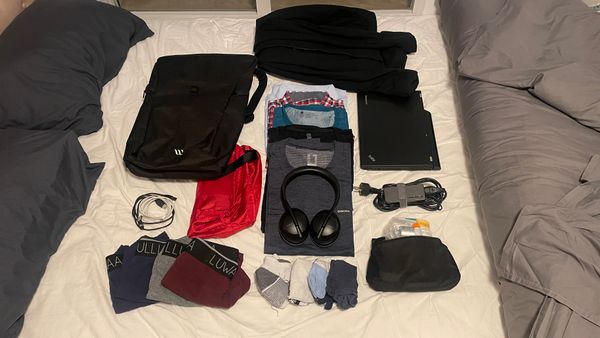My backpack, my clothes, and my gear spread out on our bed in Valencia.